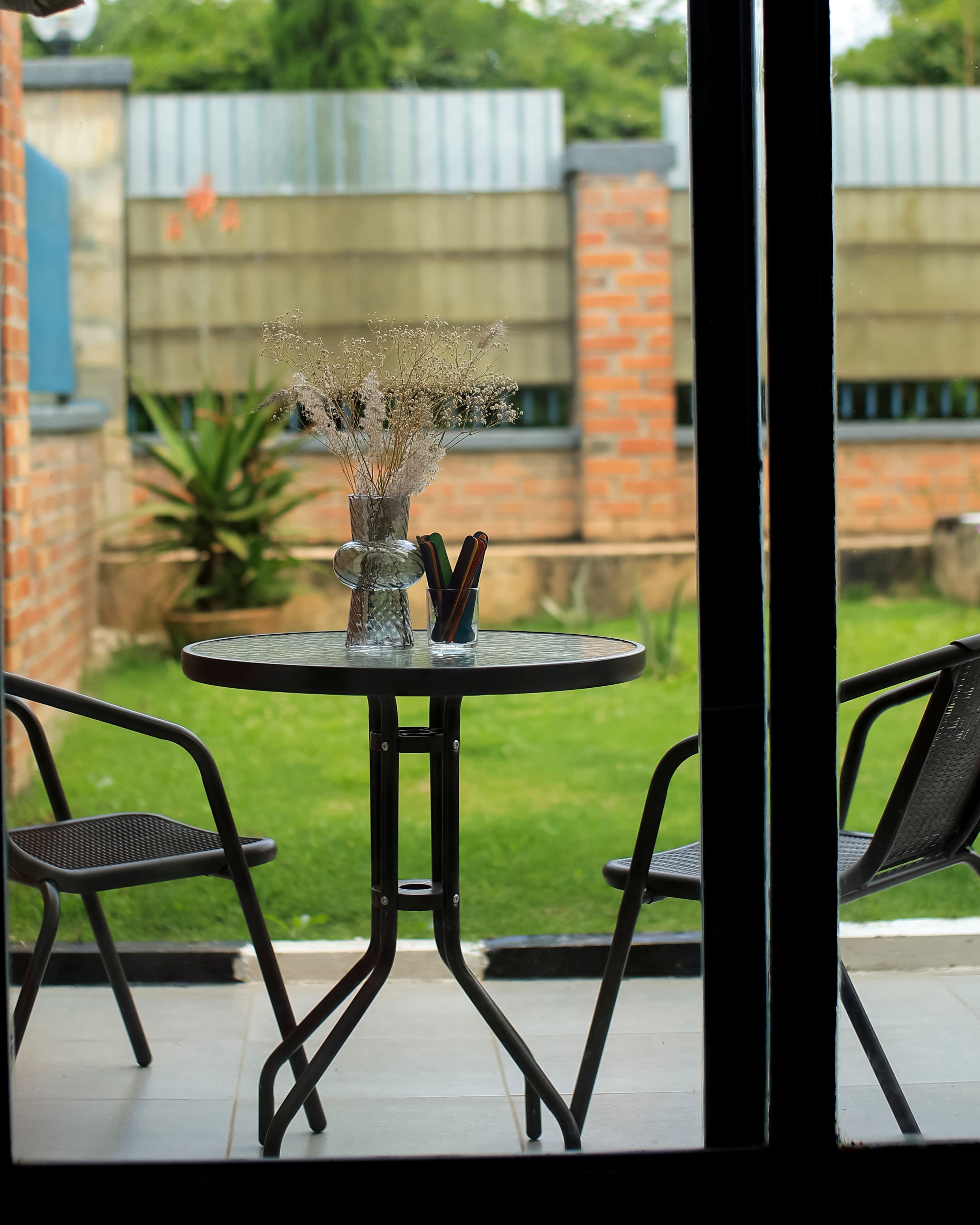 Velstays — the garden table through the glass, dried flowers